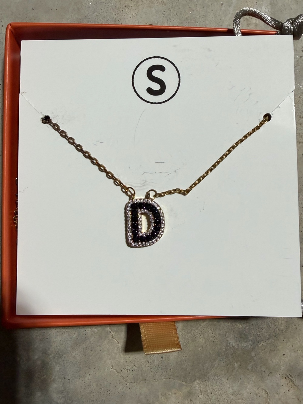 Gold Tone D-Shaped Pendant Bracelet with Black and Clear Stones